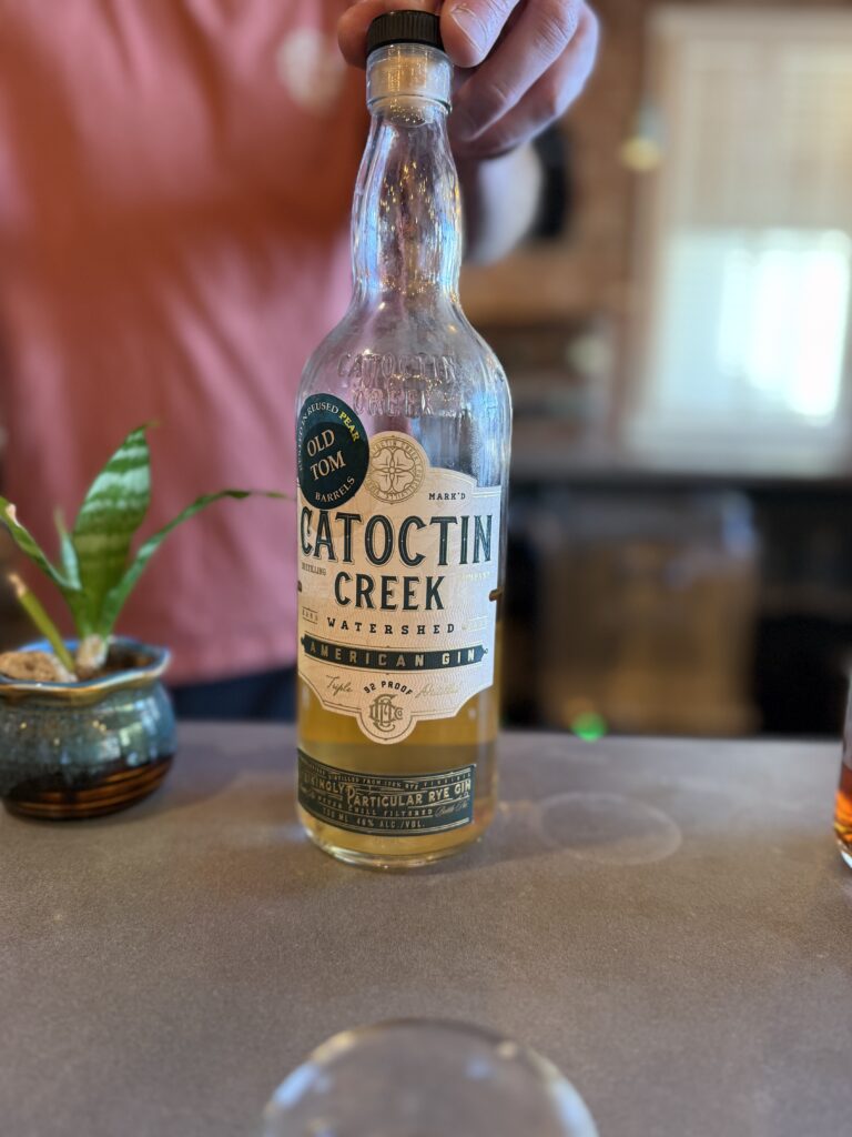 Catoctin Creek Cornerstone Club Pear Brandy finished Gin on bar beside succulent