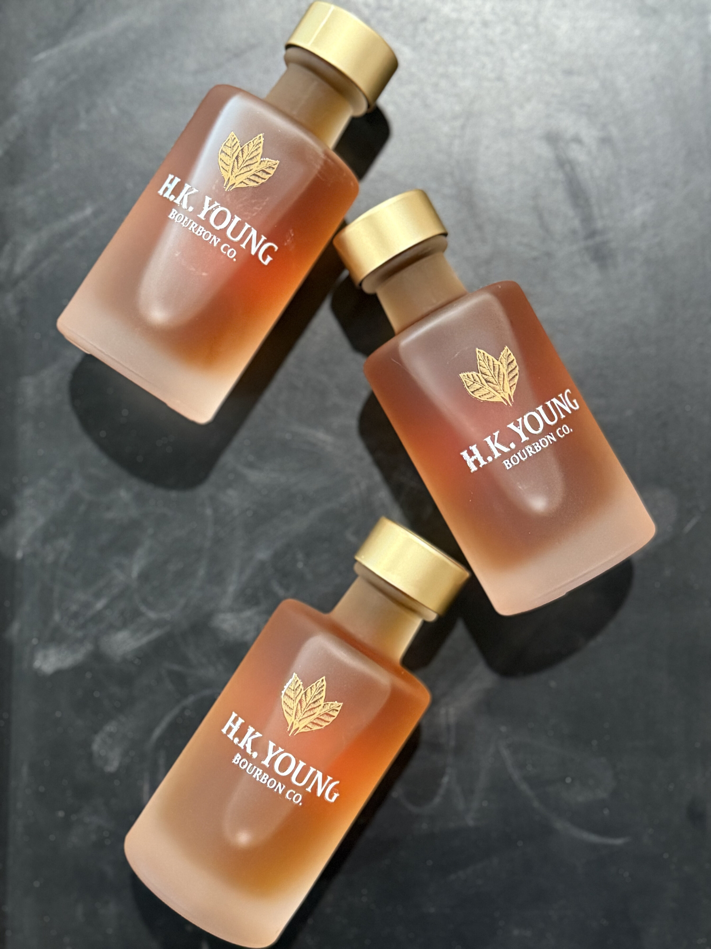 H.K. Young Toasted Bourbon Liquid Ministry Sample Bottles on chalkboard box