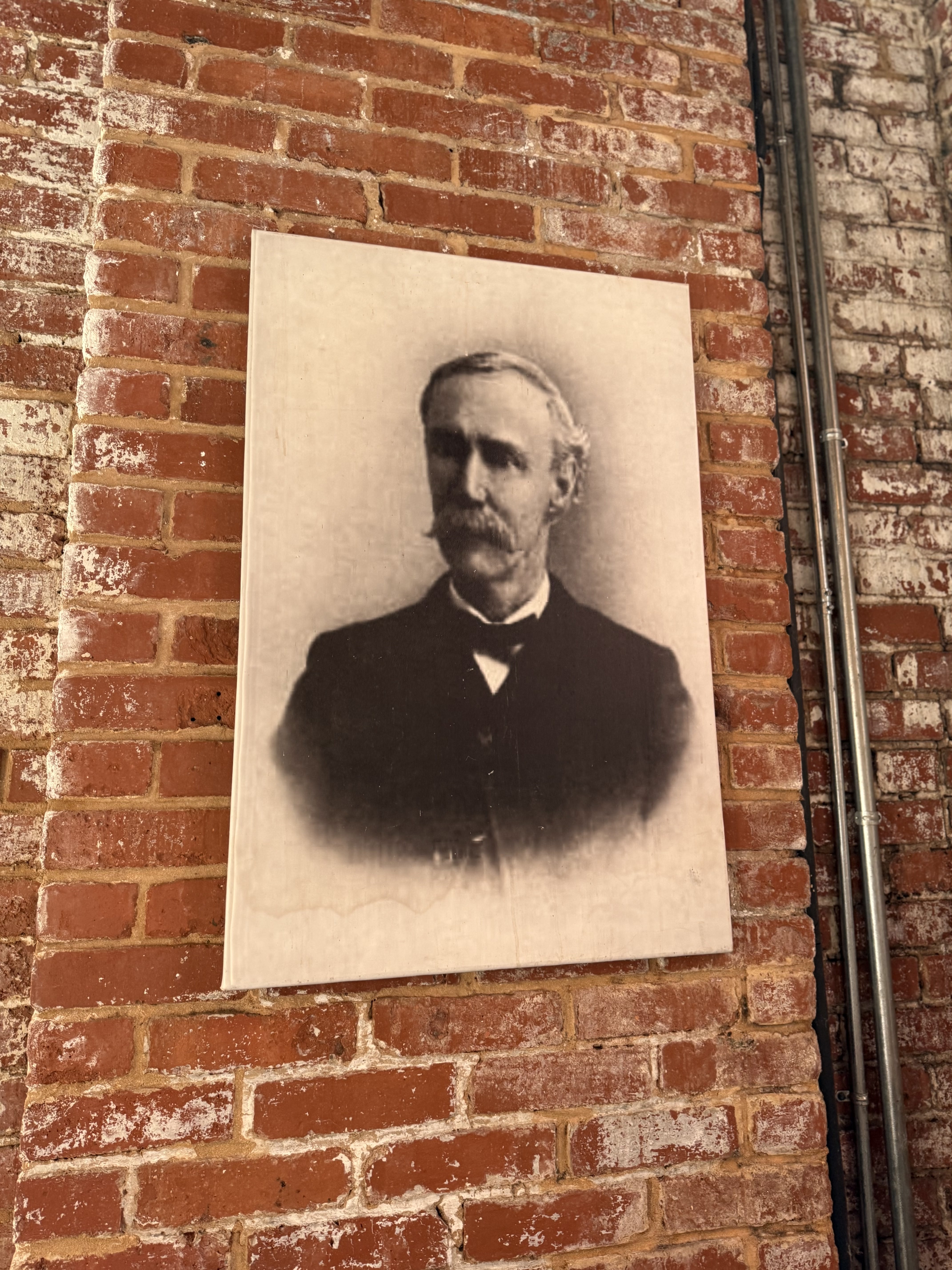Portrait of Mcclintock Young hanging in tasting room, namesake of distillery and 1800s inventor