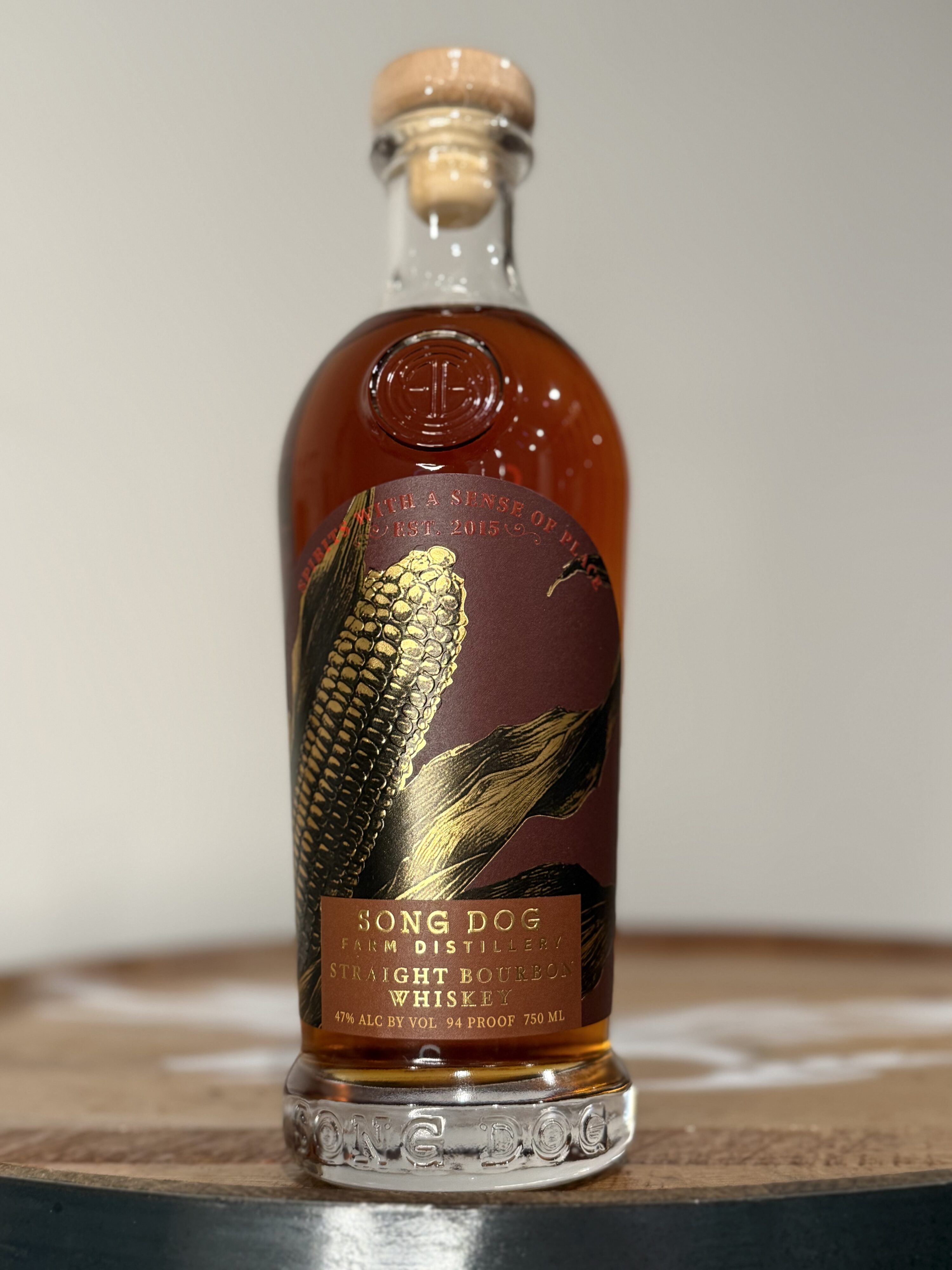 Song Dog Bourbon standing up on whiskey barrel