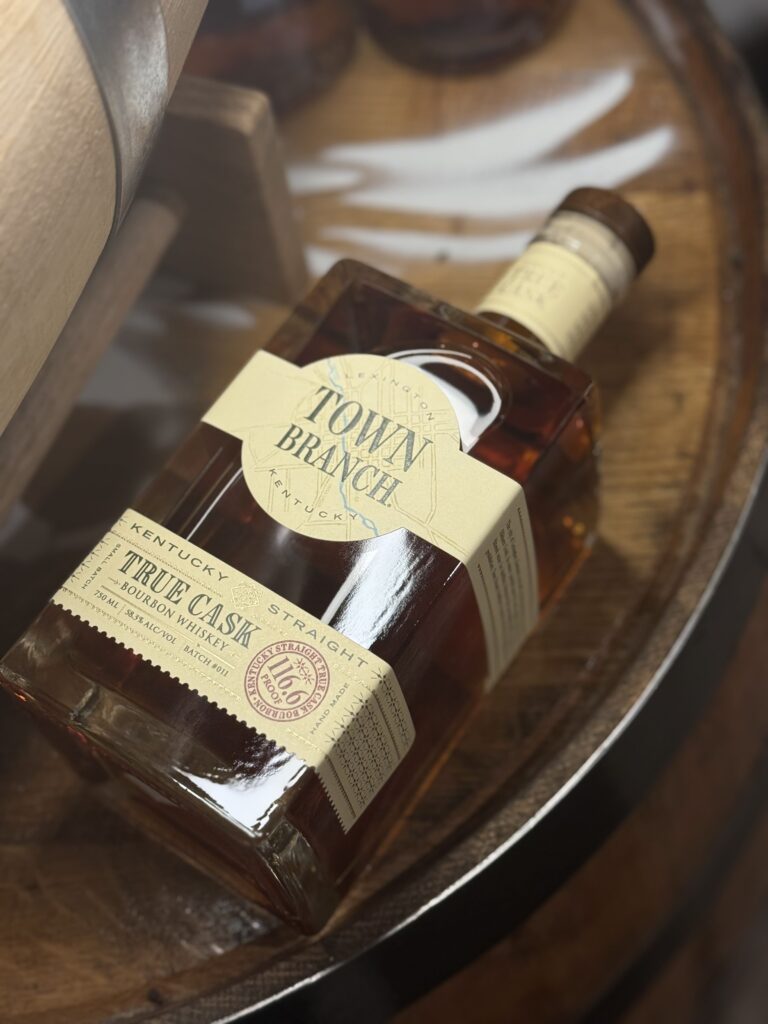 Town branch true cask 116.6 proof bourbon lying on whiskey barrel