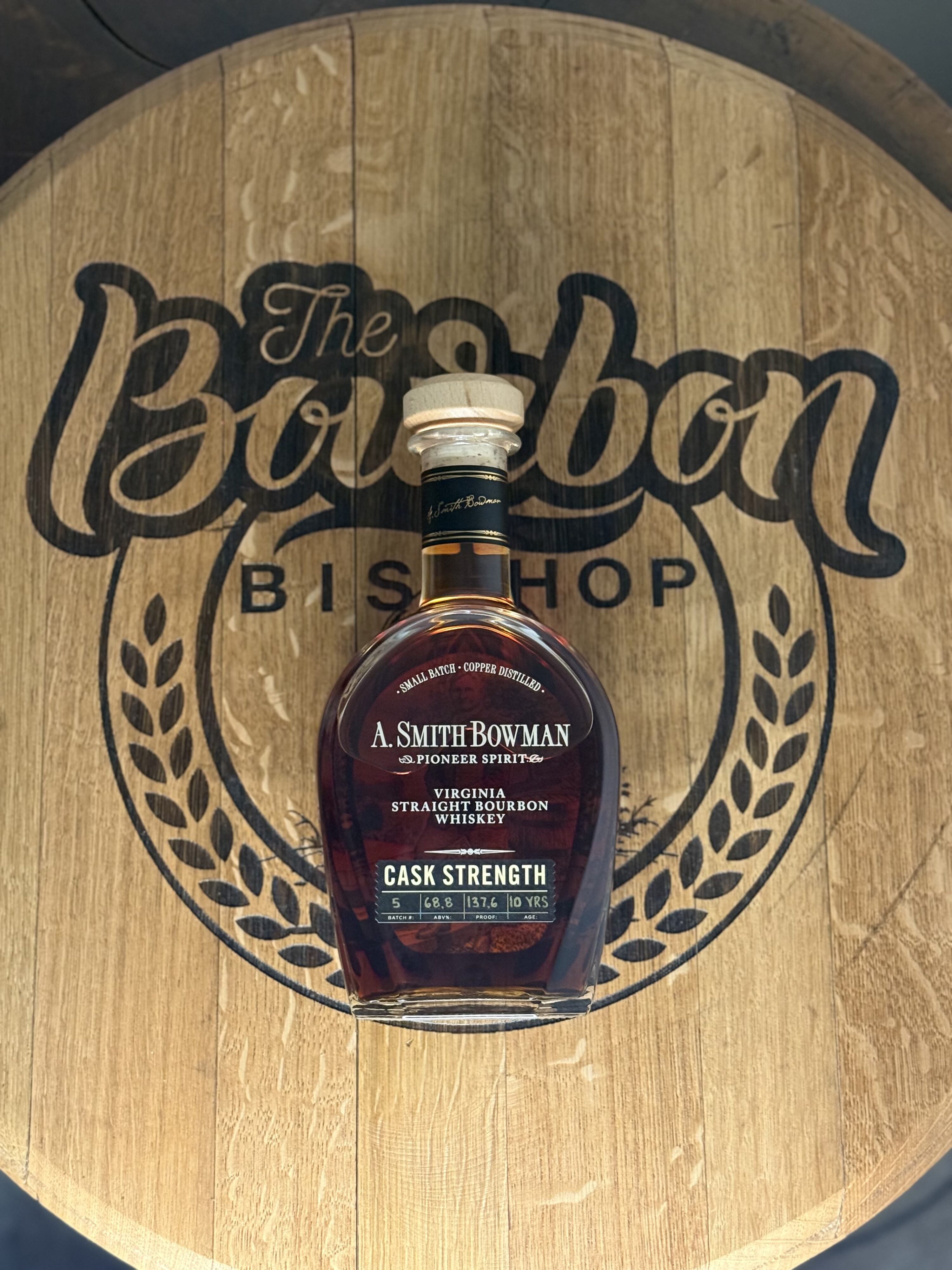 A. Smith Bowman Cask Strength Batch 5 lying on The Bourbon Bishop logo barrel head