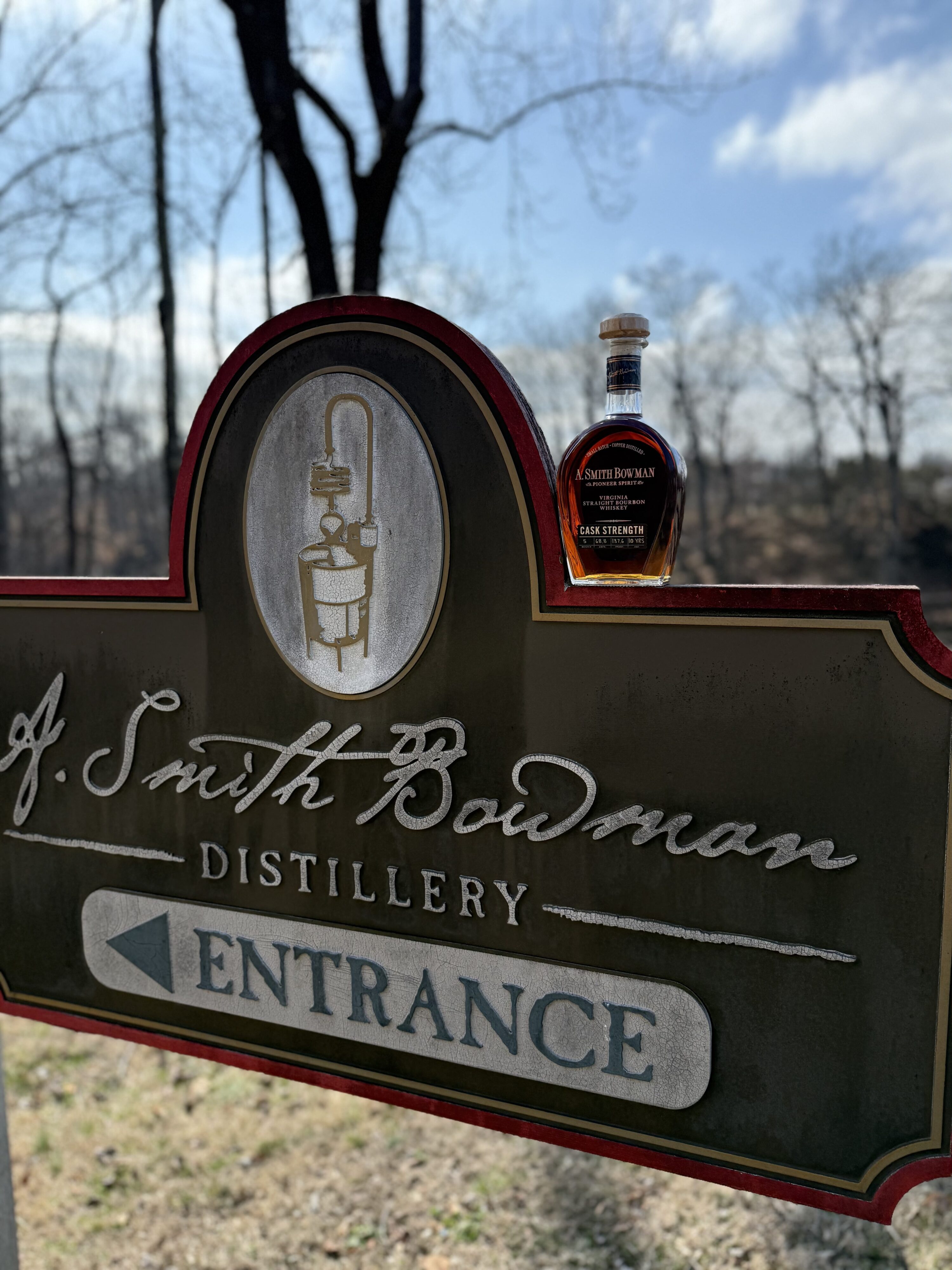 A. Smith Bowman Cask Strength Batch 5 sitting on A. Smith Bowman Distillery entrance sign