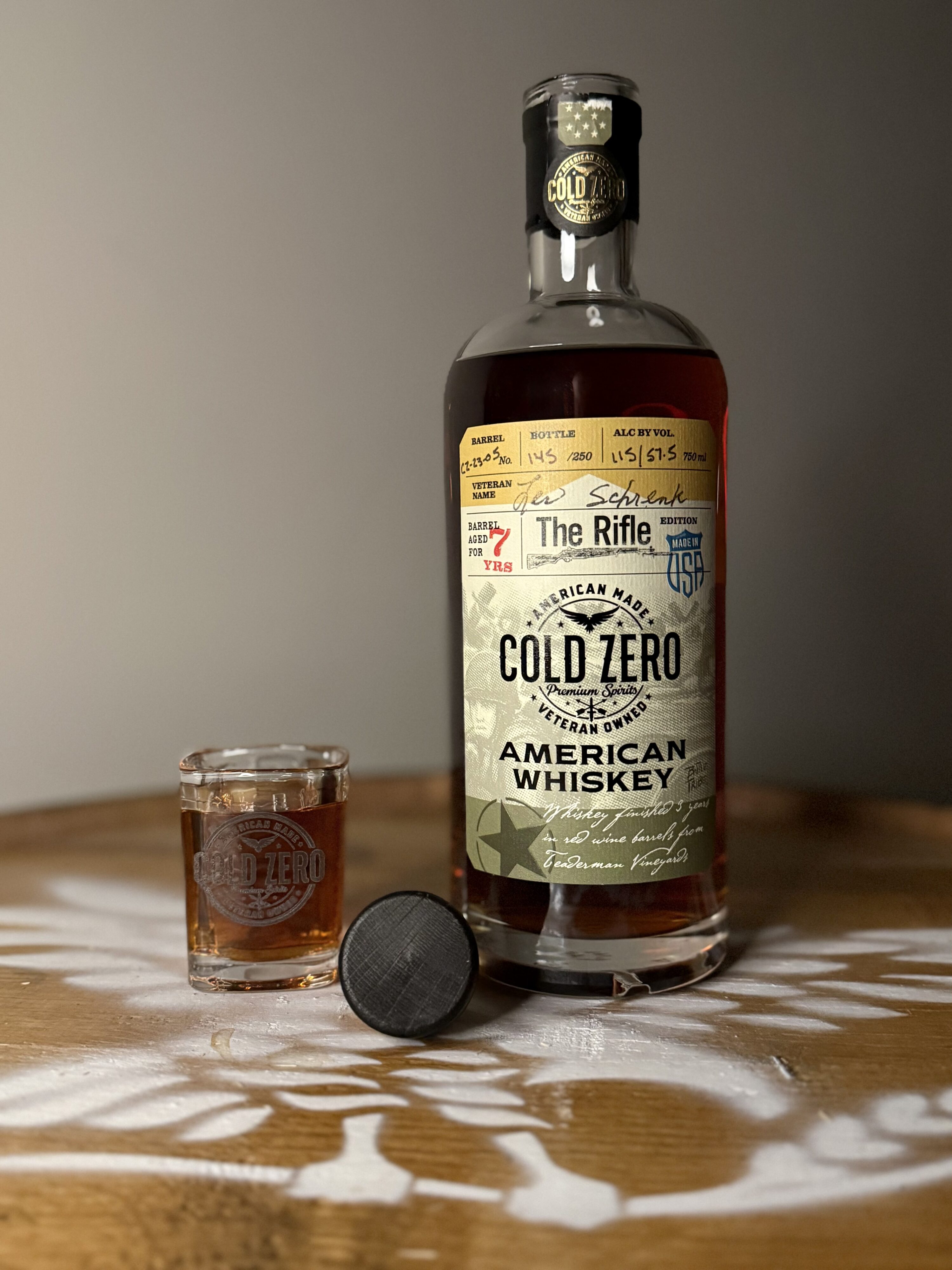 Cold Zero the Rifle edition opened with branded shot glass full of whiskey, all sitting on eagle logo whiskey barrel