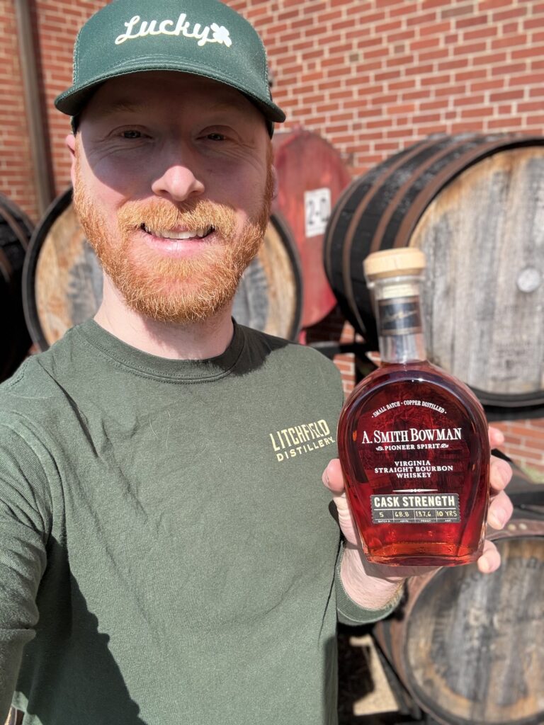 E.S. Pope standing in front of A. Smith Bowman with lottery-won A. Smith Bowman Cask Strength Batch 5