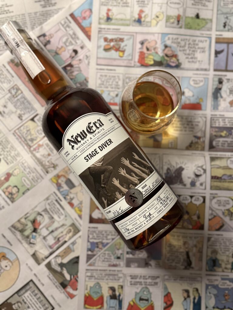 New Era Stage Diver Single Barrel lying on colorful newspaper cartoons