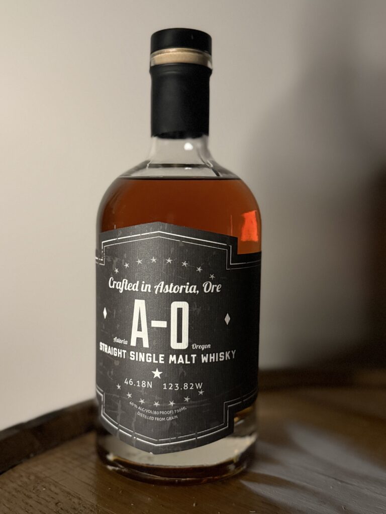 Pilot House A-O Single Malt Whiskey sitting on whiskey barrel