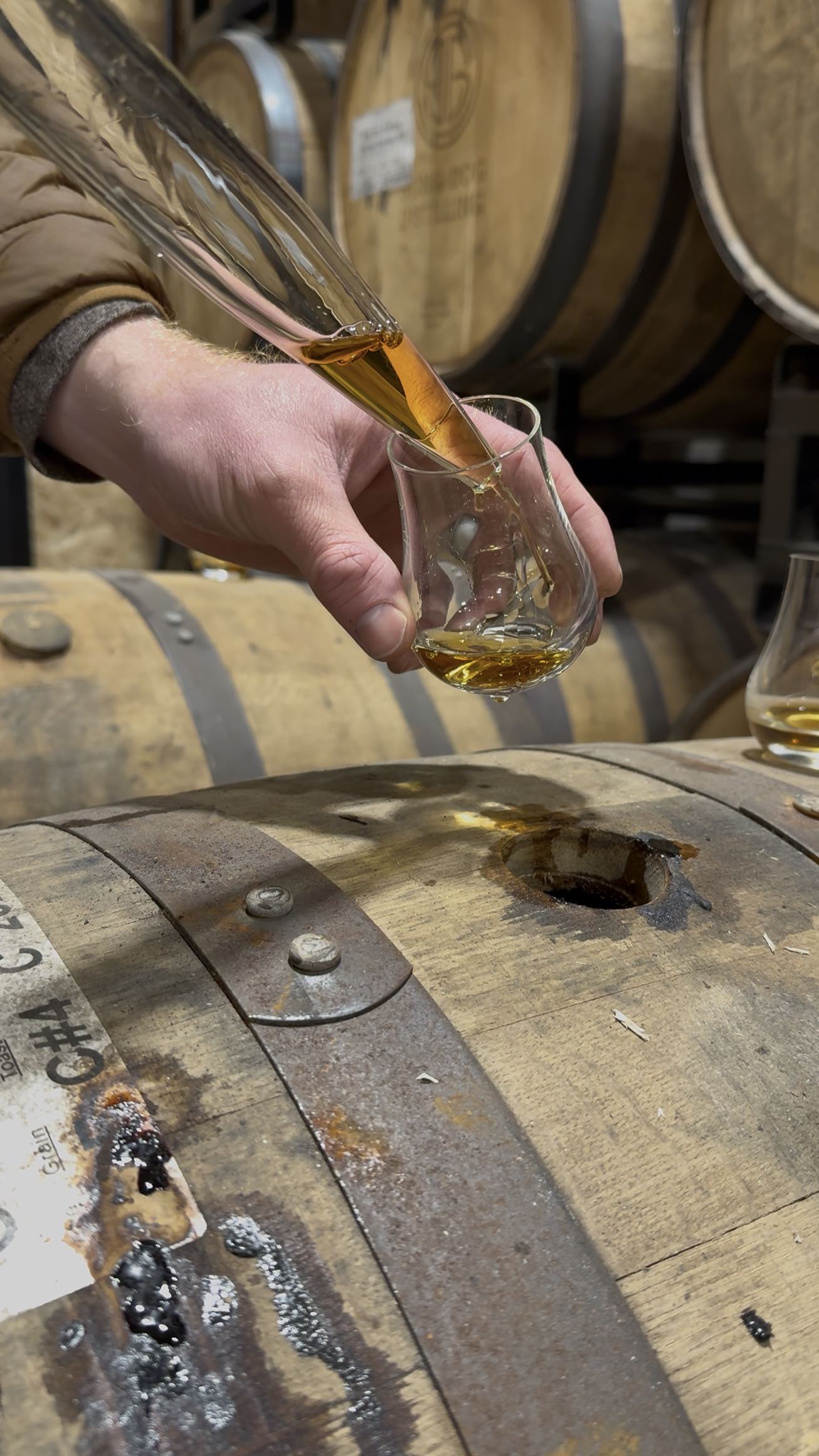 E.S. Pope pouring rye whiskey straight from the barrel close-up