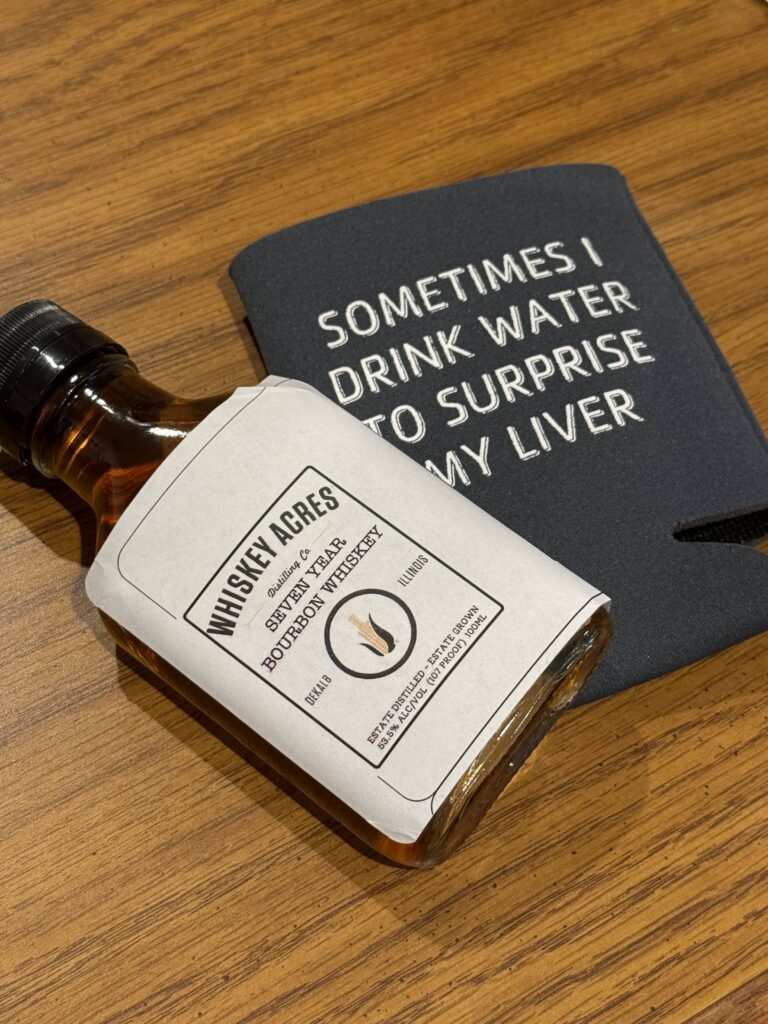 Whiskey Acres 7 Year Bourbon on beer koozie that says "sometimes I drink water to surprise my liver"