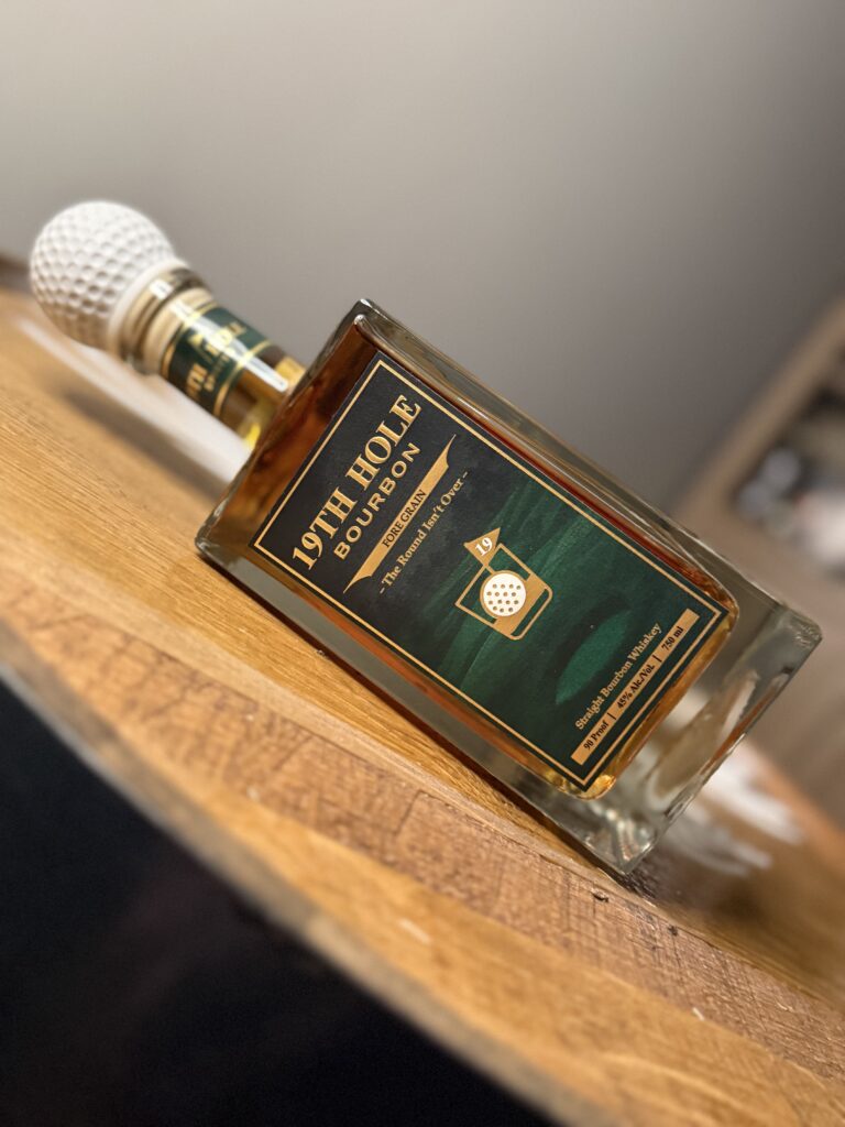 19th Hole Bourbon lying sideways on barrel