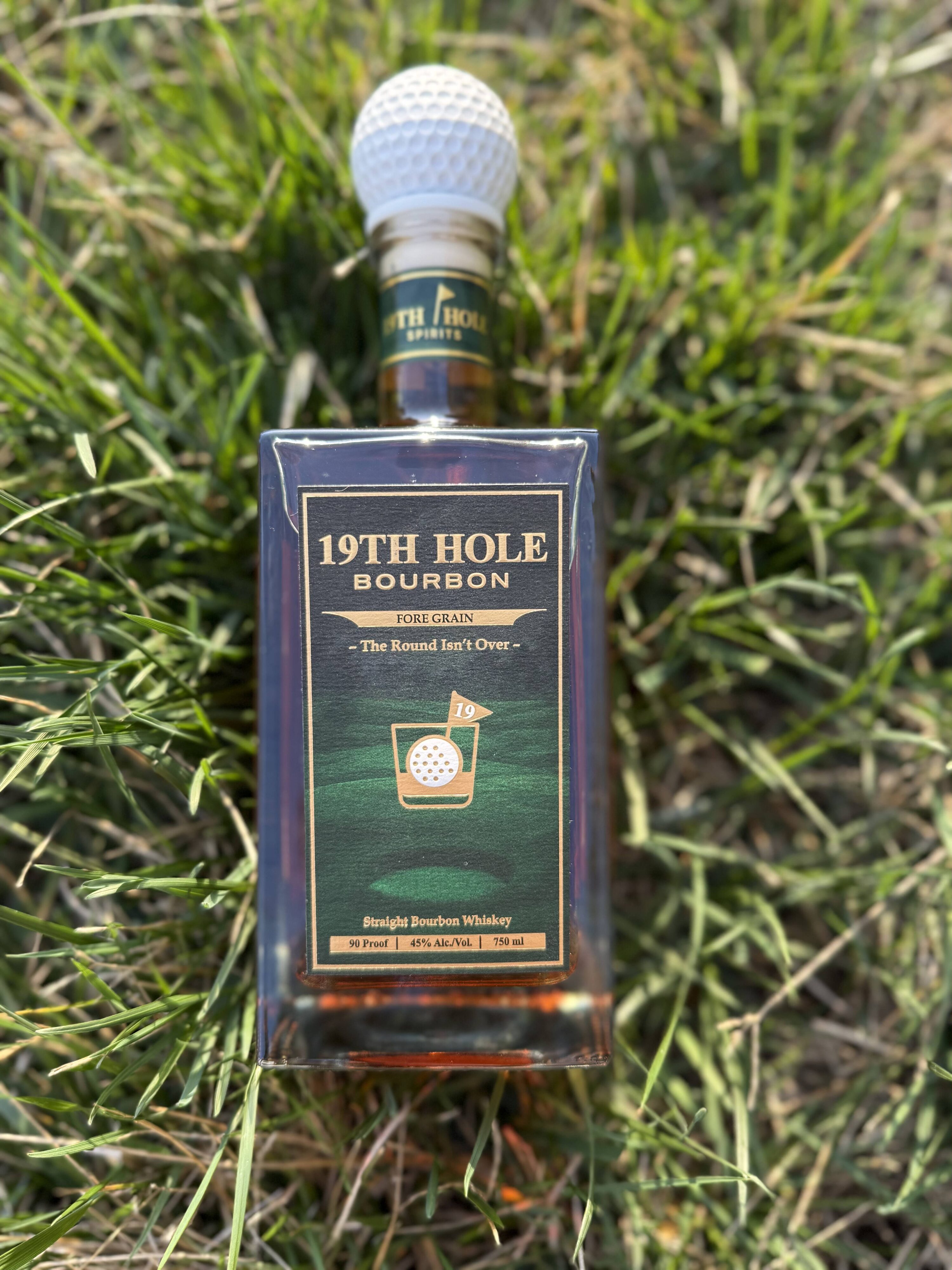 19th Hole Bourbon lying in grass