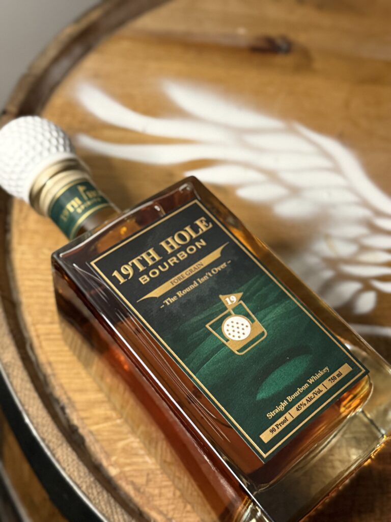 19th Hole Bourbon lying on whiskey barrel against eagle logo