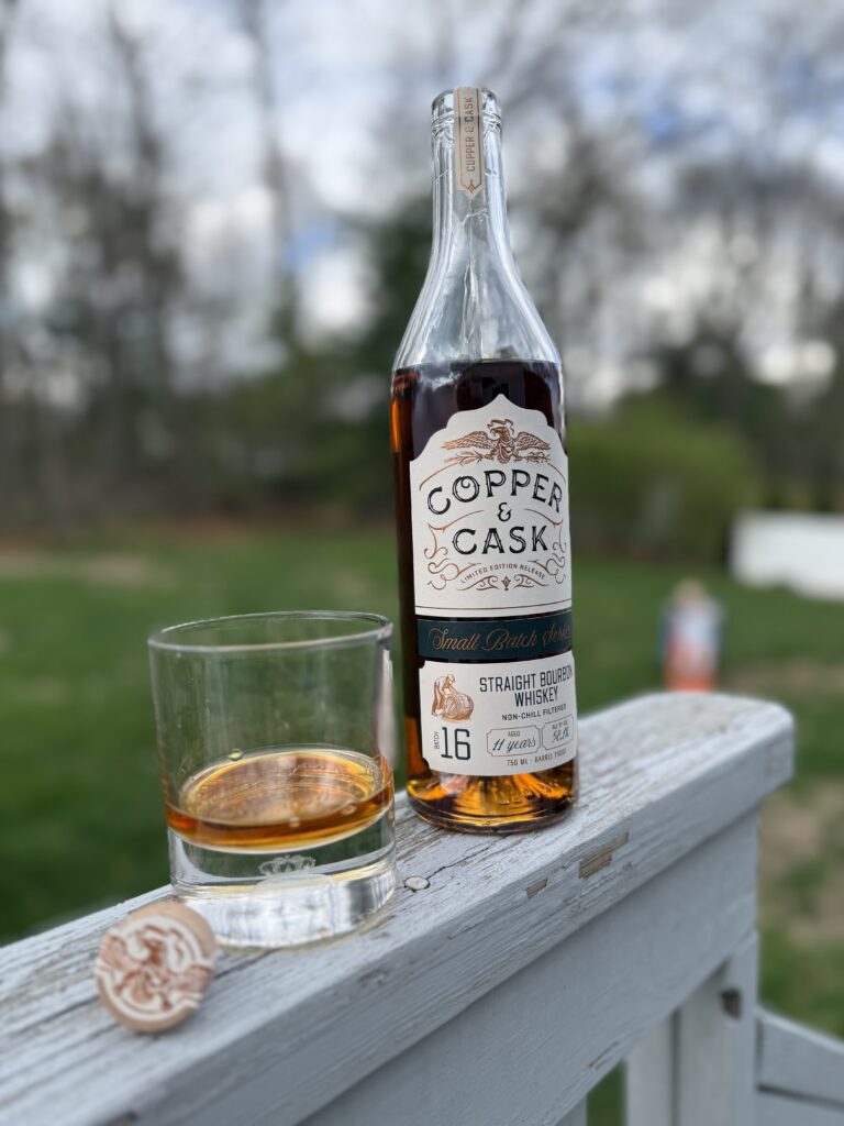 Copper & Cask Small Batch Series 16 open and poured on deck railing