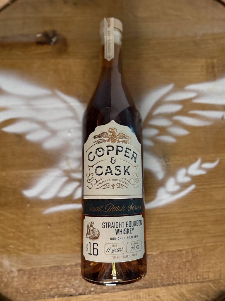 Copper & Cask Small Batch Series 16 lying on whiskey barrel with eagle logo