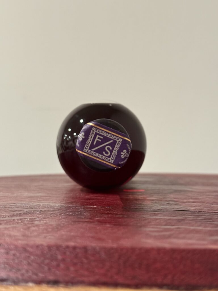 Forward Slash Quintessium topper over wine red barrel stave