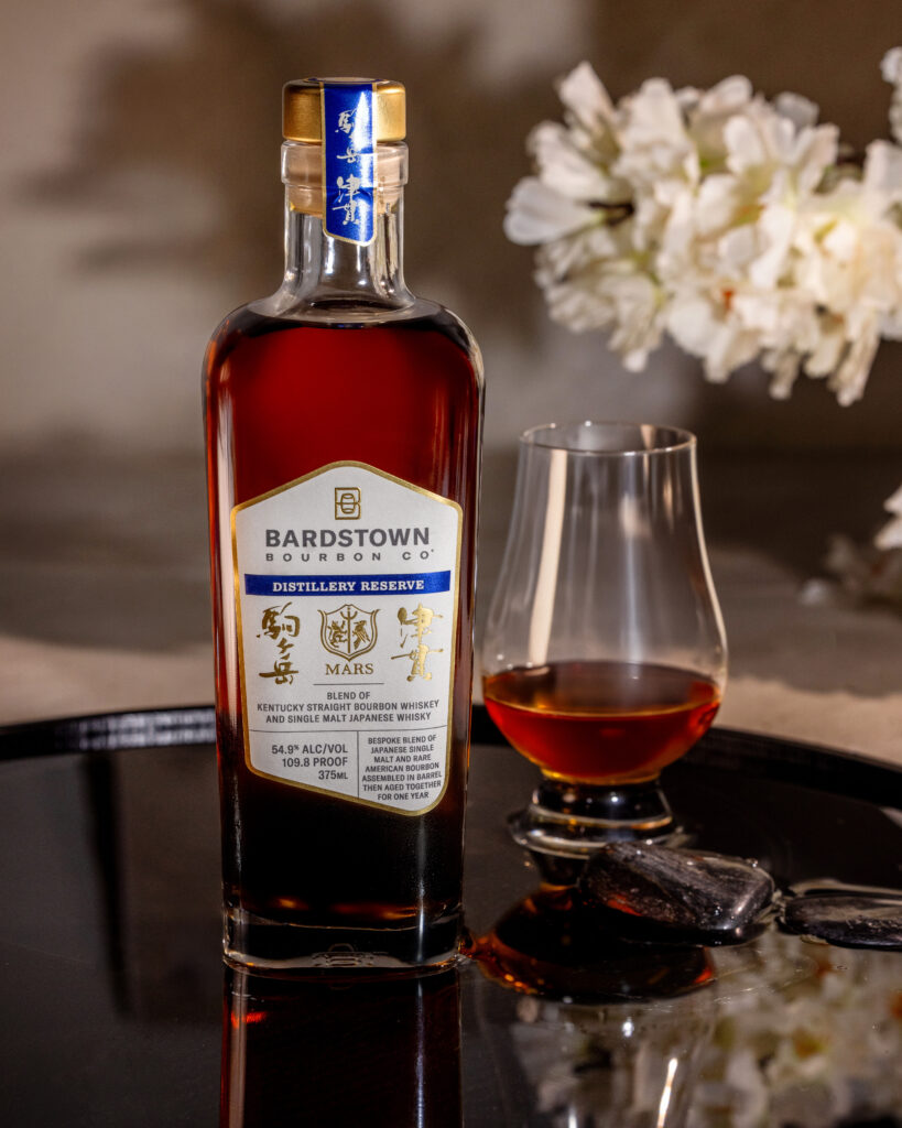 Bardstown Bourbon Company's Distillery Reserve Mars Blend beside full glass and blooms