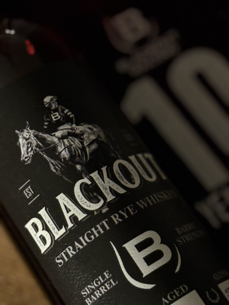 Blackout 10 Year Cask Strength Single Barrel Rye angled close-up label beside 10 year bag.
