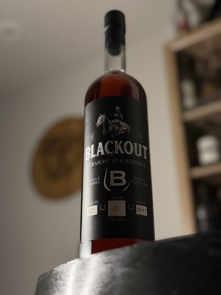 Blackout 10 Year Cask Strength Single Barrel Rye standing on barrel