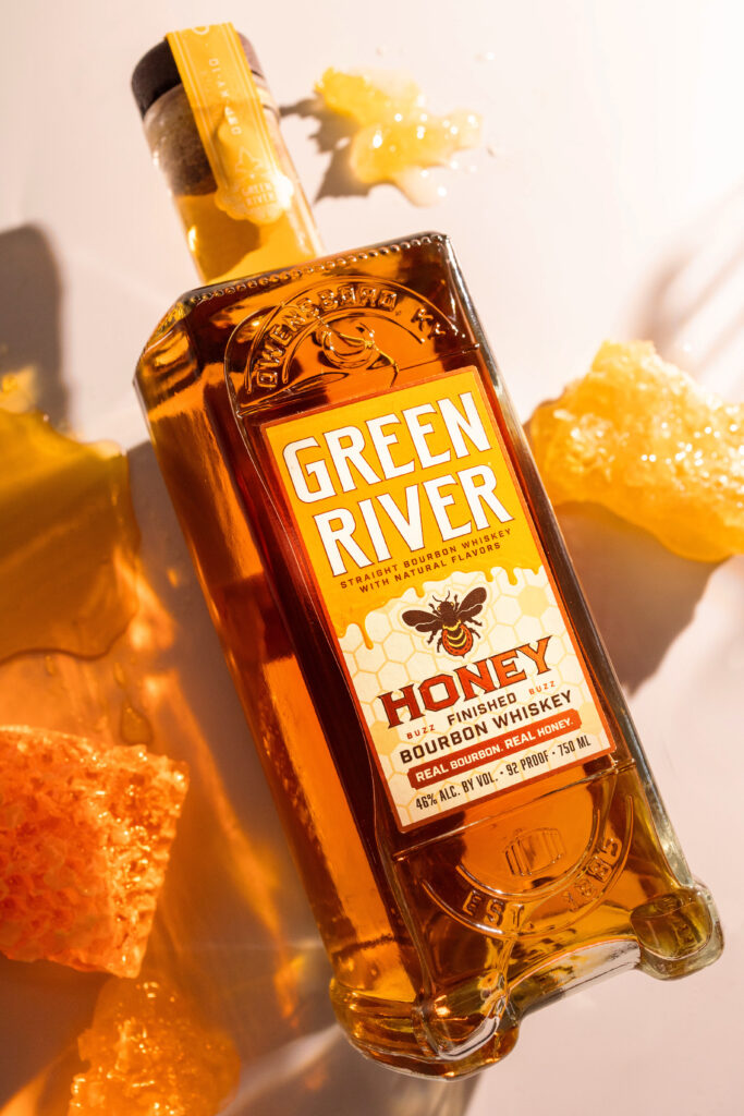 Green River Honey Bourbon lying beside honeycomb