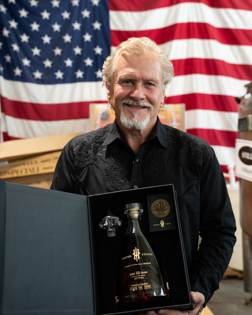Norm Hooten holding boxed Hooten Young Constitution Hull Reserve