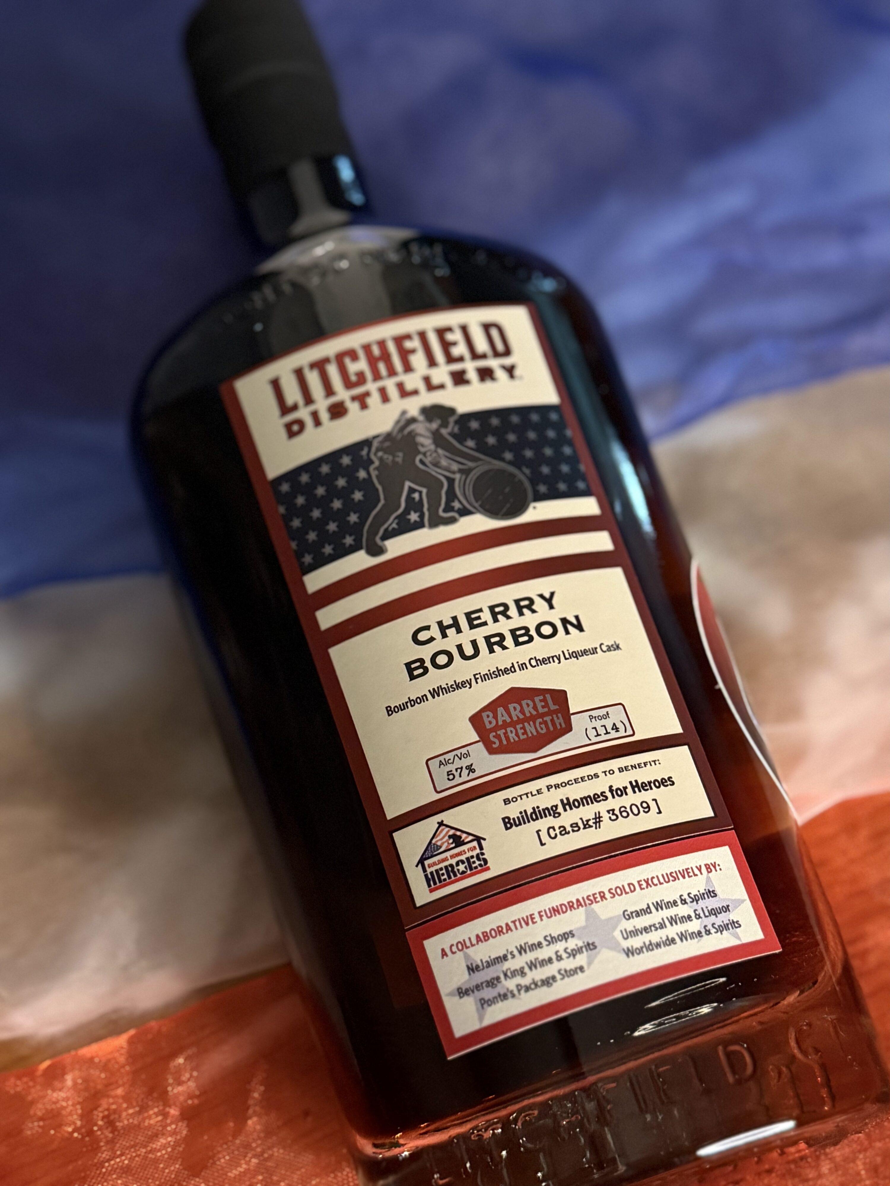 Litchfield Cherry Bourbon lying over red white and blue stripes