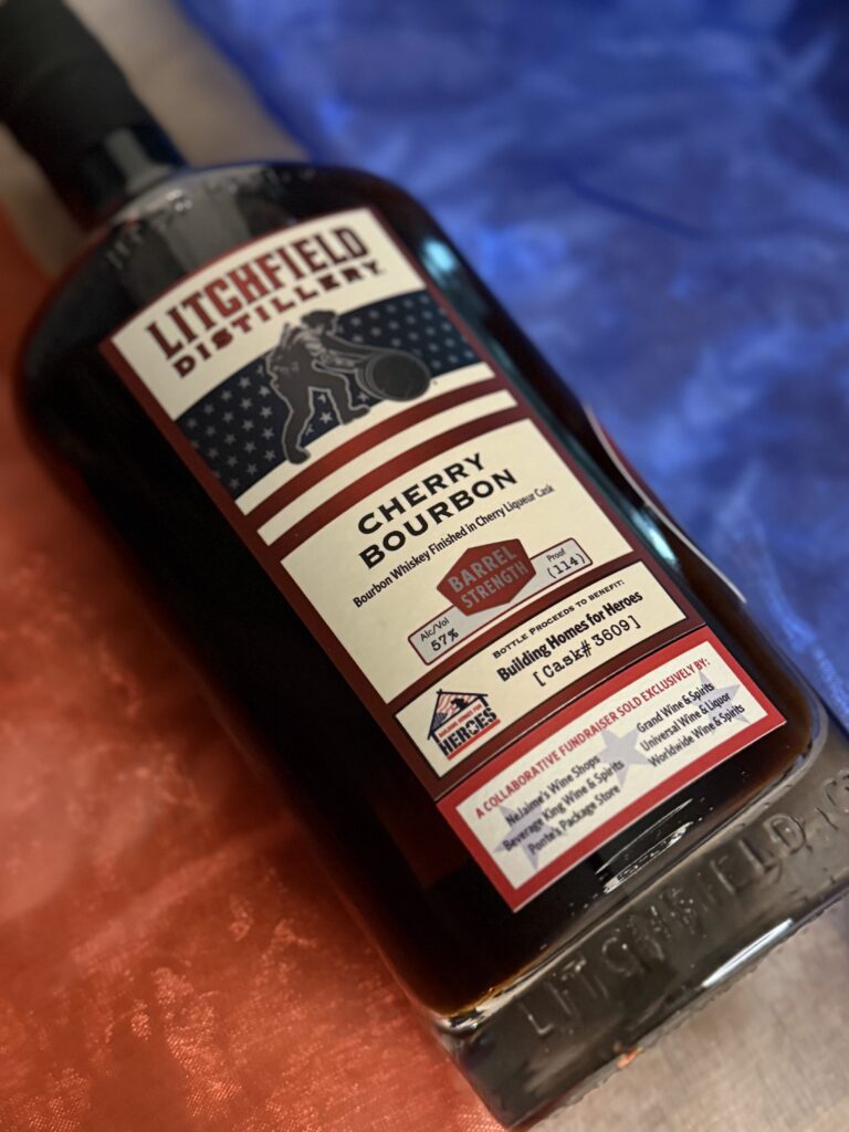 Litchfield Cherry Bourbon angled over red white and blue stripes