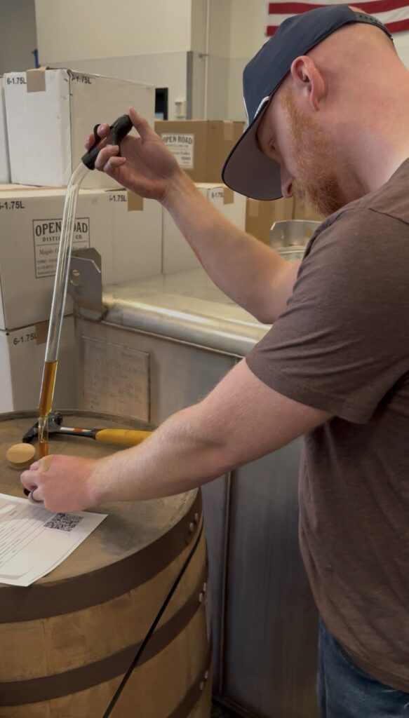 Ethan thieves one of the Texas whiskey barrels into 10 ml graduated cylinder.