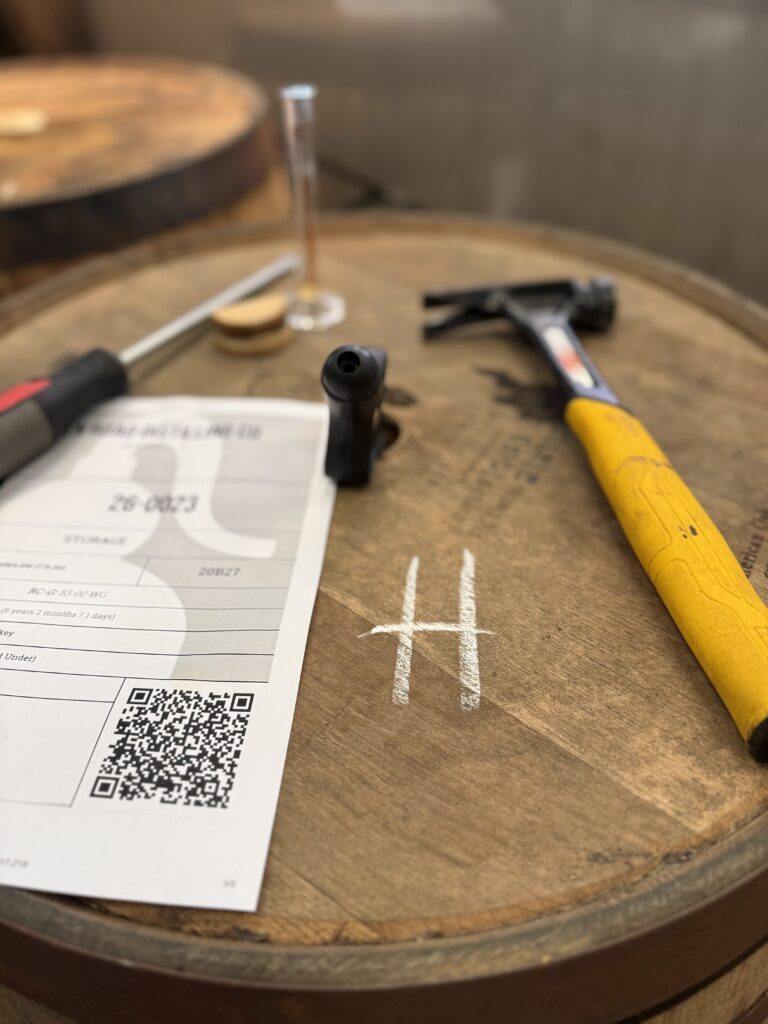 Tools of the trade: a hammer, screwdriver sit on top of a barrel beside thief still within the barrel