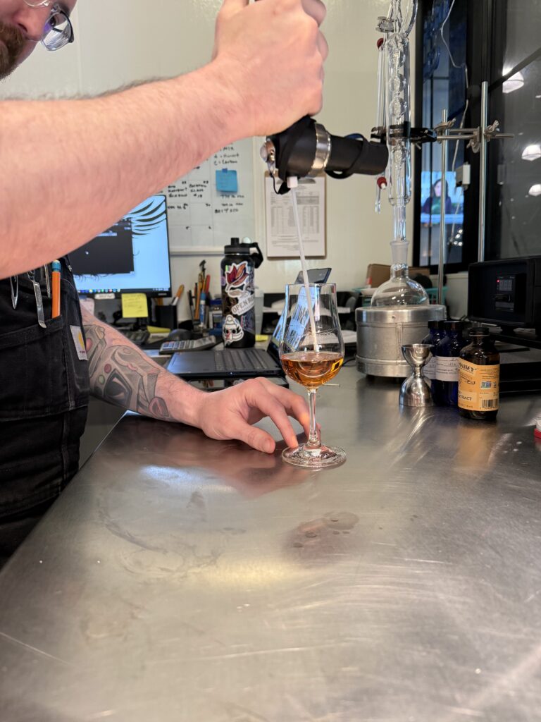 Michael takes the hydrometer reading for the proof of the initial blend