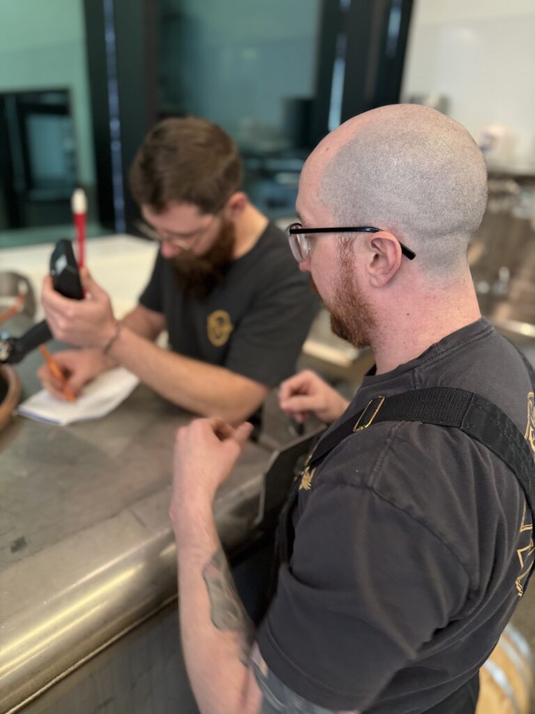 Michael instructs Kirby on his labeling system for the bourbon coupe samples