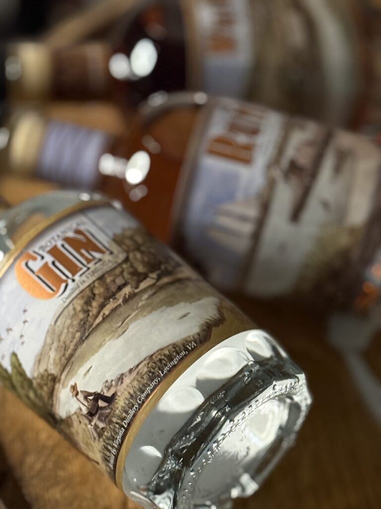 VA 250th Trio gin lying with blurred other bottles