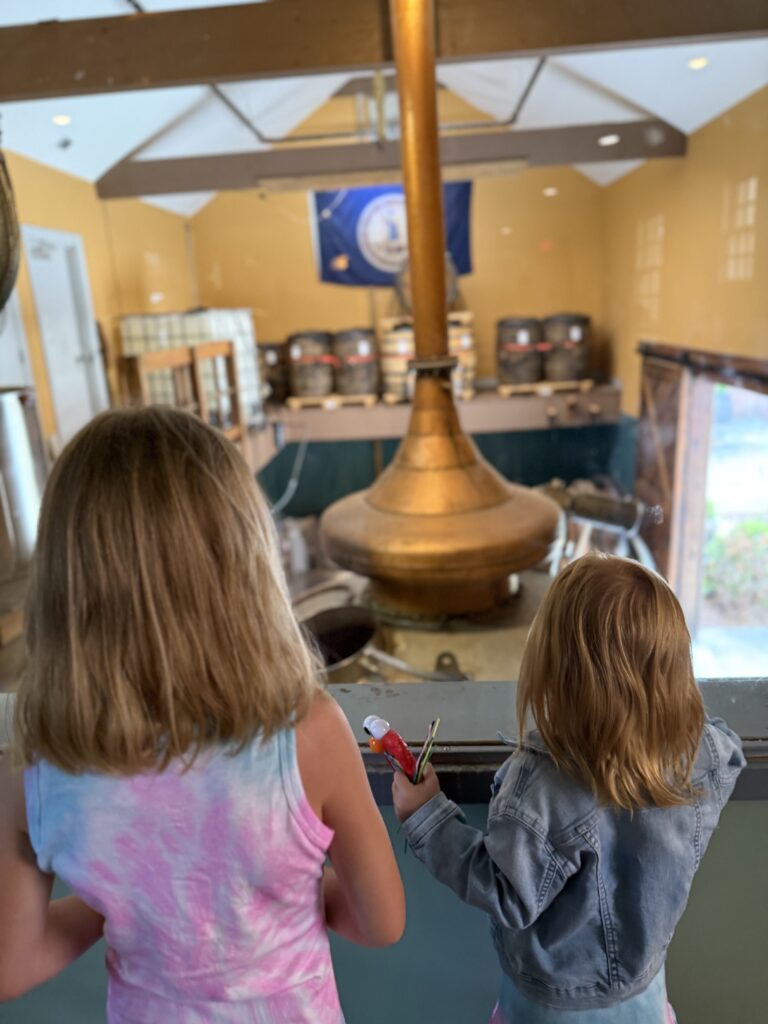 Ethan's kids look into Copper Fox distillation and malting room with copper pot still