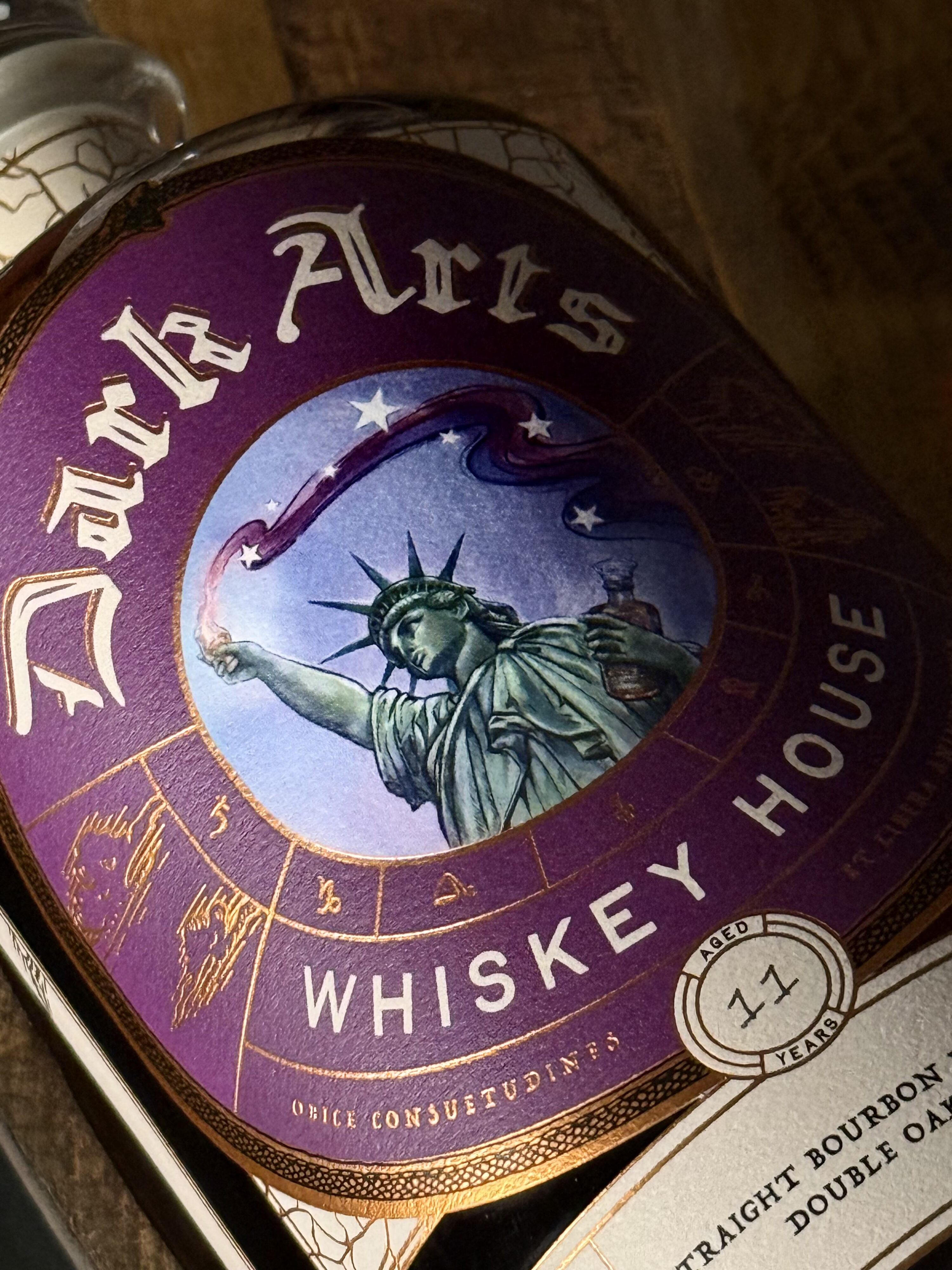Dark Arts 250th anniversary release: Lady Liberty holds the glencairn of whiskey high with magic/alchemy energy streaming from it