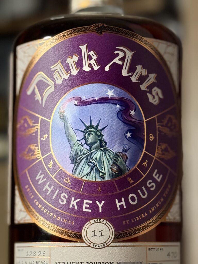 Dark Arts 250th anniversary release: Lady Liberty holds the glencairn of whiskey high with magic/alchemy energy streaming from it