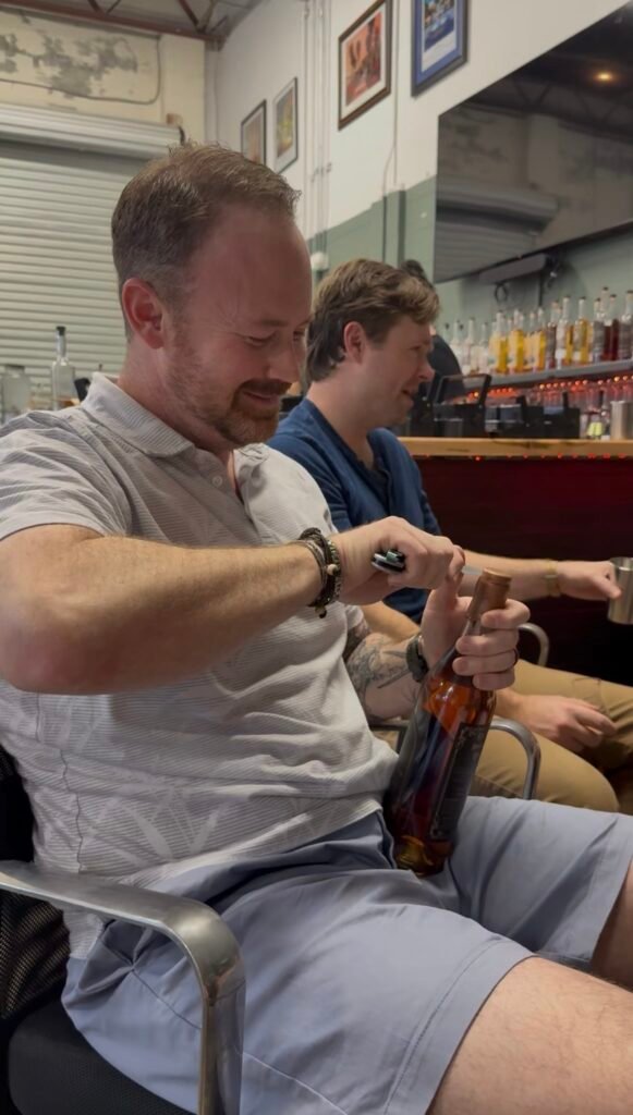 Michael opens a wax top bottle for the bottle share