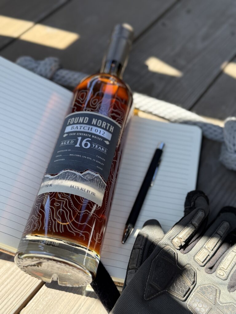 Found North Cask Strength Batch 012 lying on notebook with pen, gloves, rope