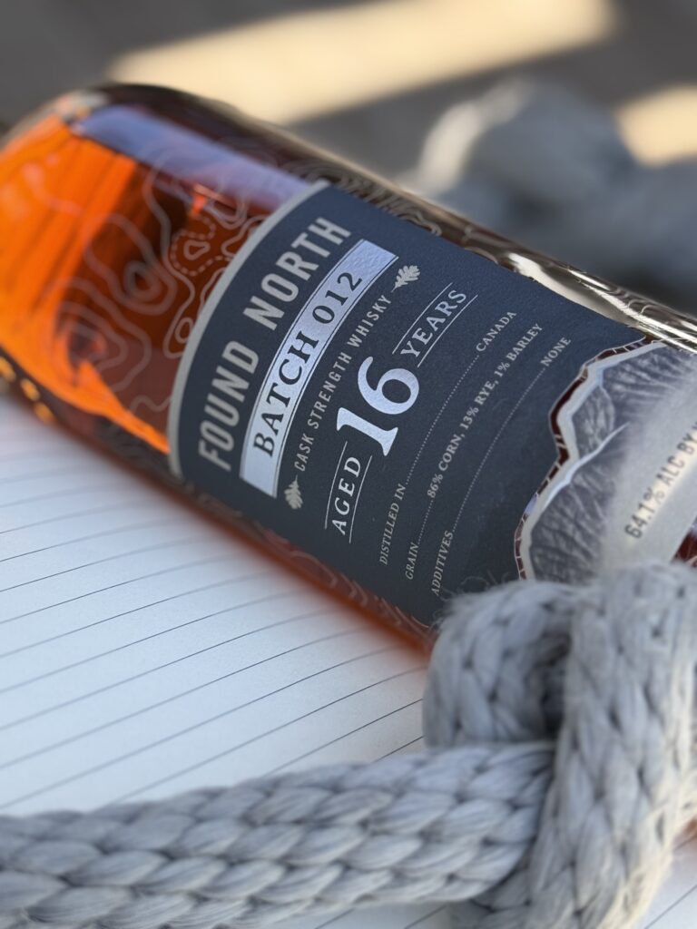 Found North Cask Strength Batch 012 lying on notebook with pen close-up