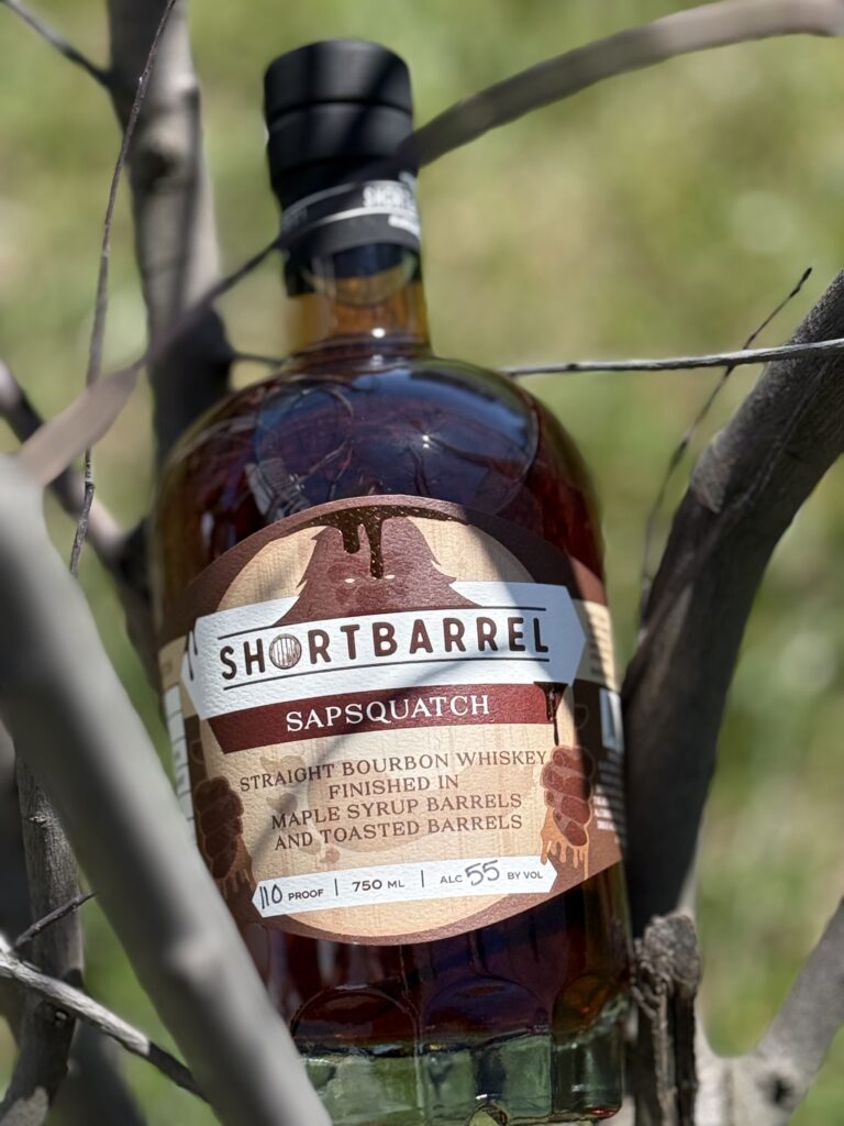 Shortbarrel Sapsquatch Maple-Finished Bourbon 2026 Release through branches close-up