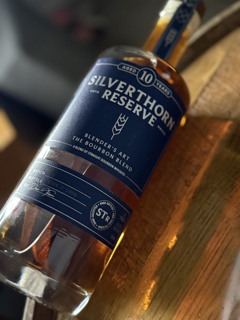 Silverthorn Reserve 10 Year High Malt Bourbon blend lying on whiskey barrel