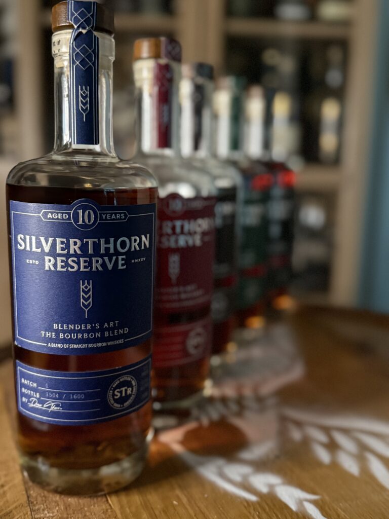 Silverthorn Reserve 10 Year High Malt Bourbon blend in front of blurred past releases