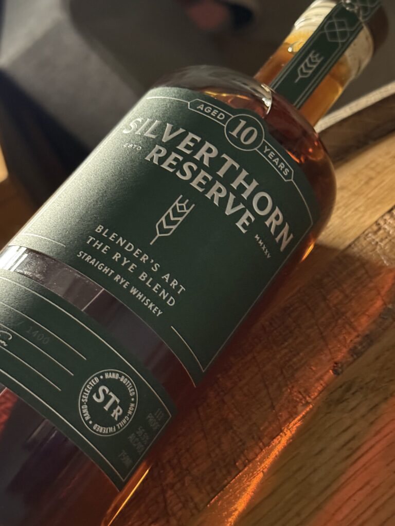 Silverthorn Reserve 10 Year Rye blend lying on whiskey barrel