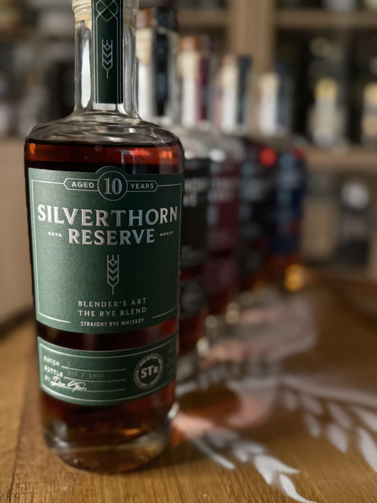 Silverthorn Reserve 10 Year Rye blend in front of blurred past releases