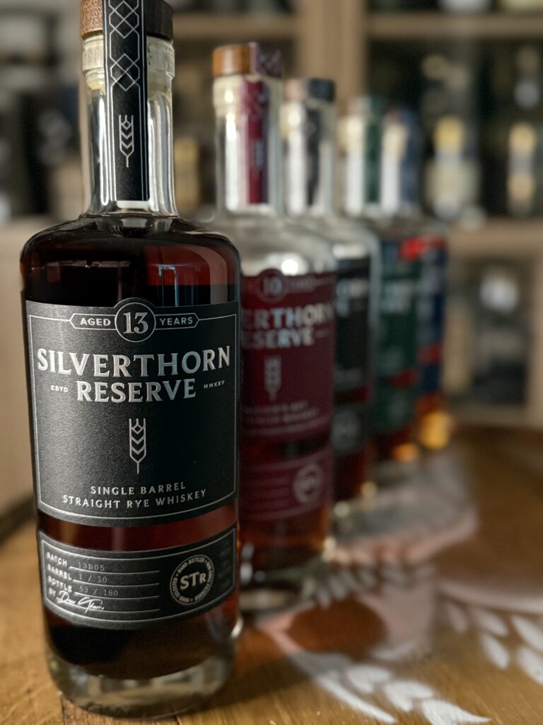 Silverthorn Reserve 13 year rye in front of past releases