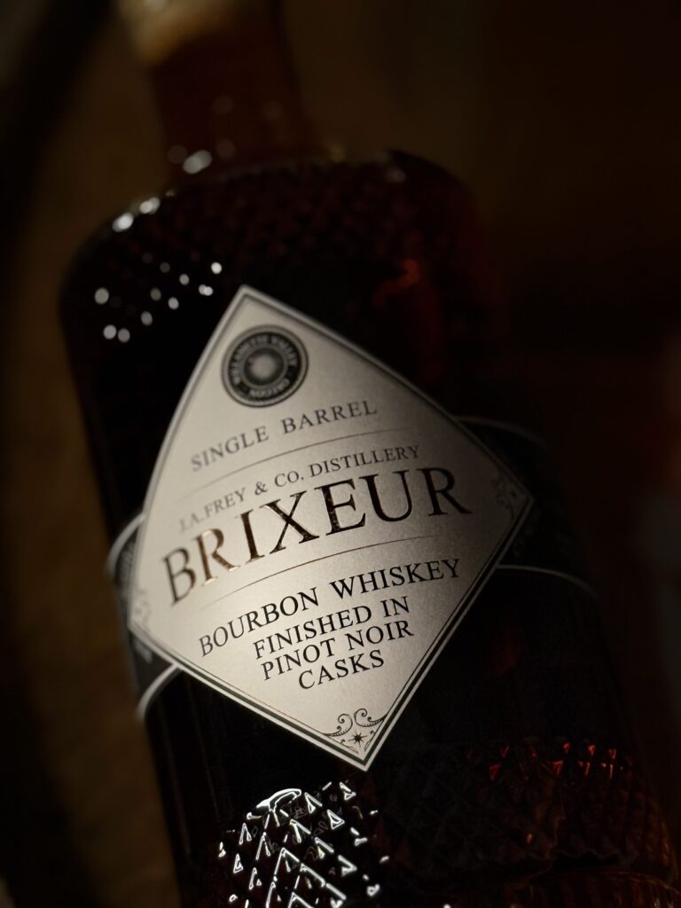 Brixeur Spirits Triple Wine Finished Bourbon lying in dark