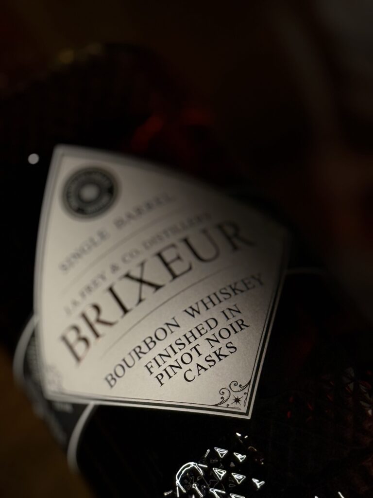 Brixeur Spirits Triple Wine Finished Bourbon lying in dark close-up