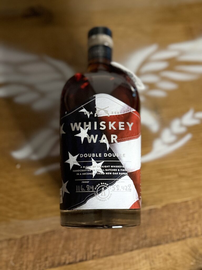 High Banks Whiskey War Double Double Oak 250th Anniversary Release lying on whiskey barrel eagle logo
