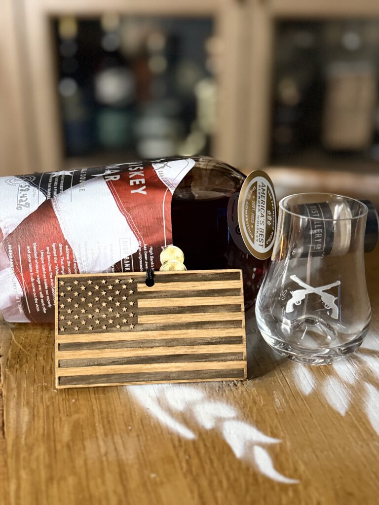 High Banks Whiskey War Double Double Oak 250th Anniversary Release on side with High Banks 250th Anniversary tag and whiskey war glass in front