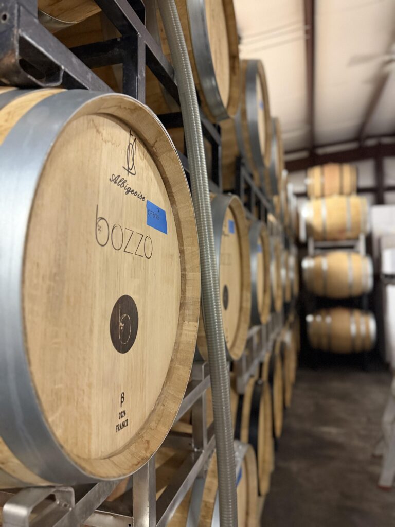 Barrels of wine sit aging in the old converted horse stable of Hillsborough Vineyards