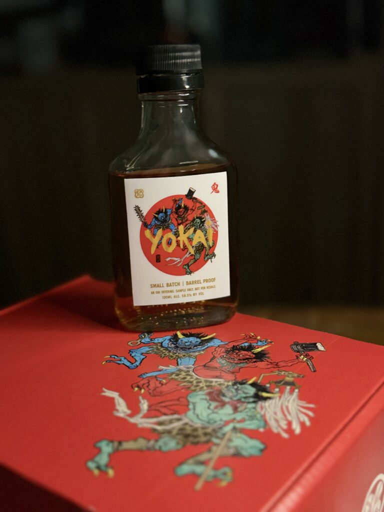 Mugen Oni Barrel Proof Small Batch sample standing on Oni art box