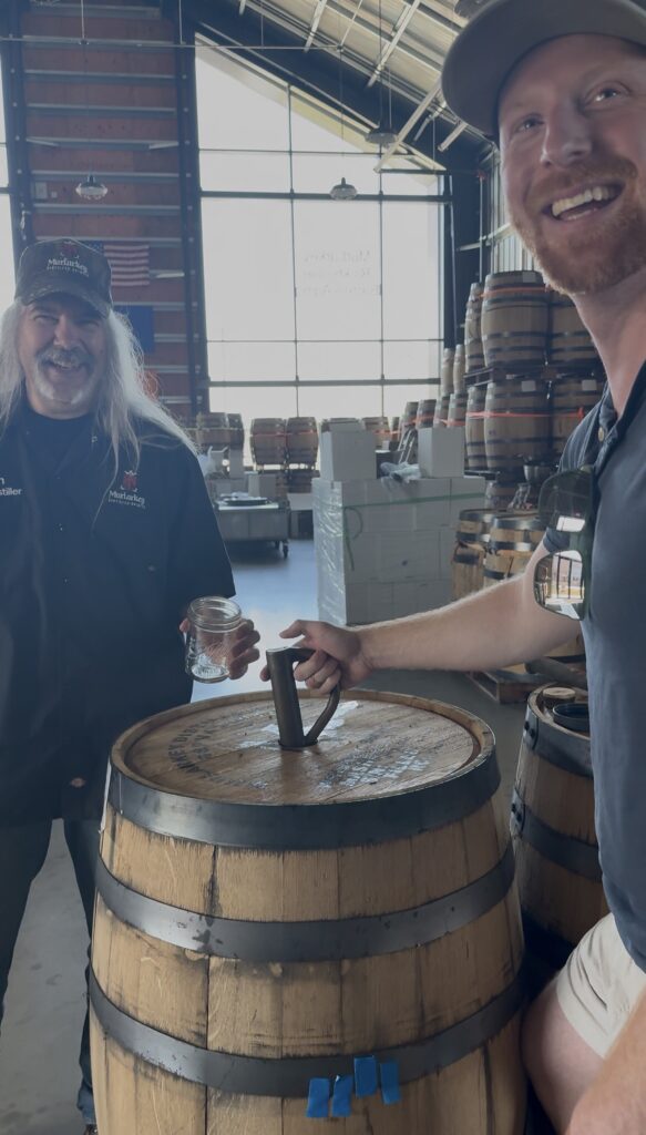 MurLarkey head distiller Kevin Szady and author Ethan Pope laugh as Nicole records them thieving straight from the barrel
